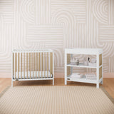 white with driftwood changing table and mini crib in nursery