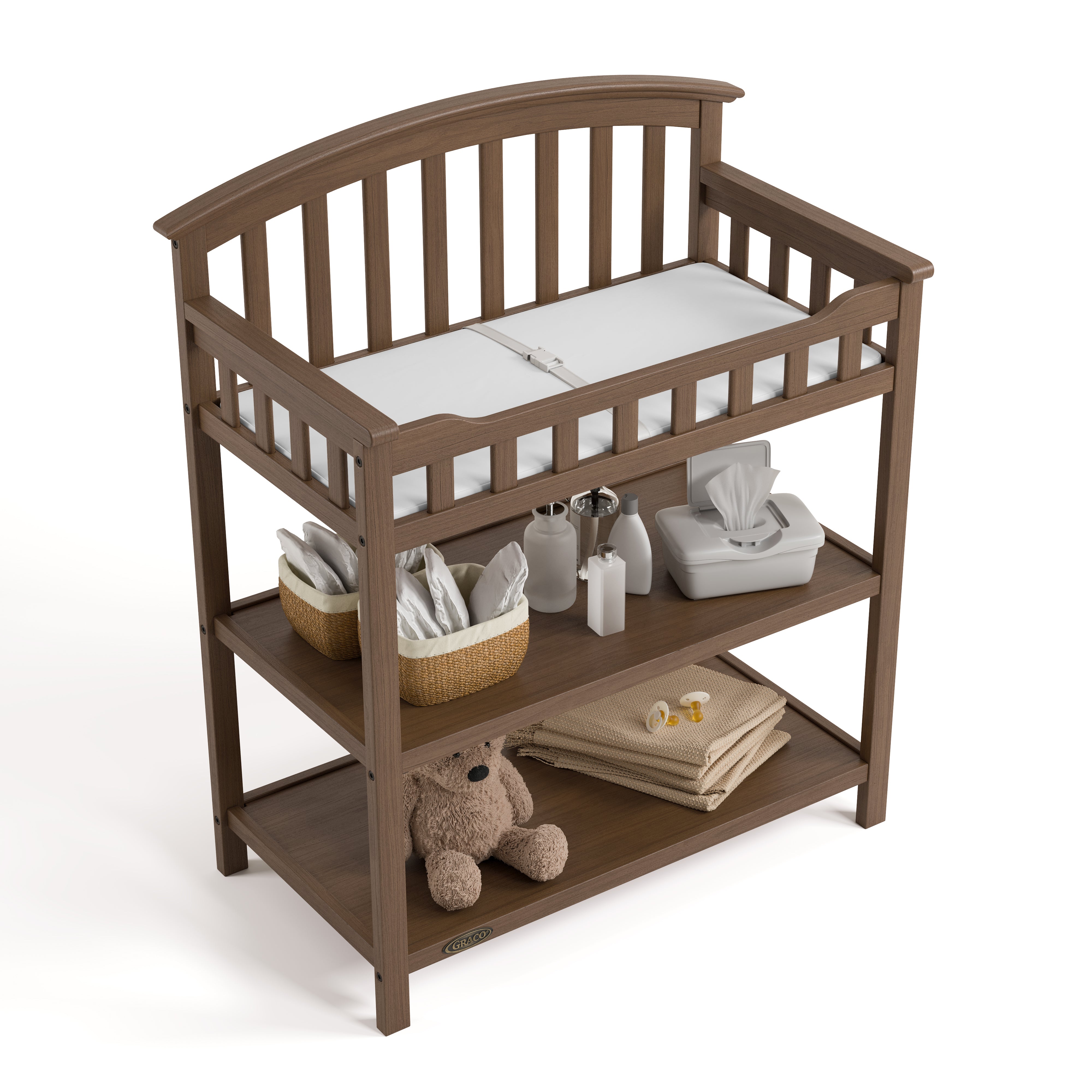 Graco hazelnut changing table top view with baby items on bottom shelves