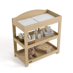 Graco driftwood customizable changing table top view with baby items on bottom shelves