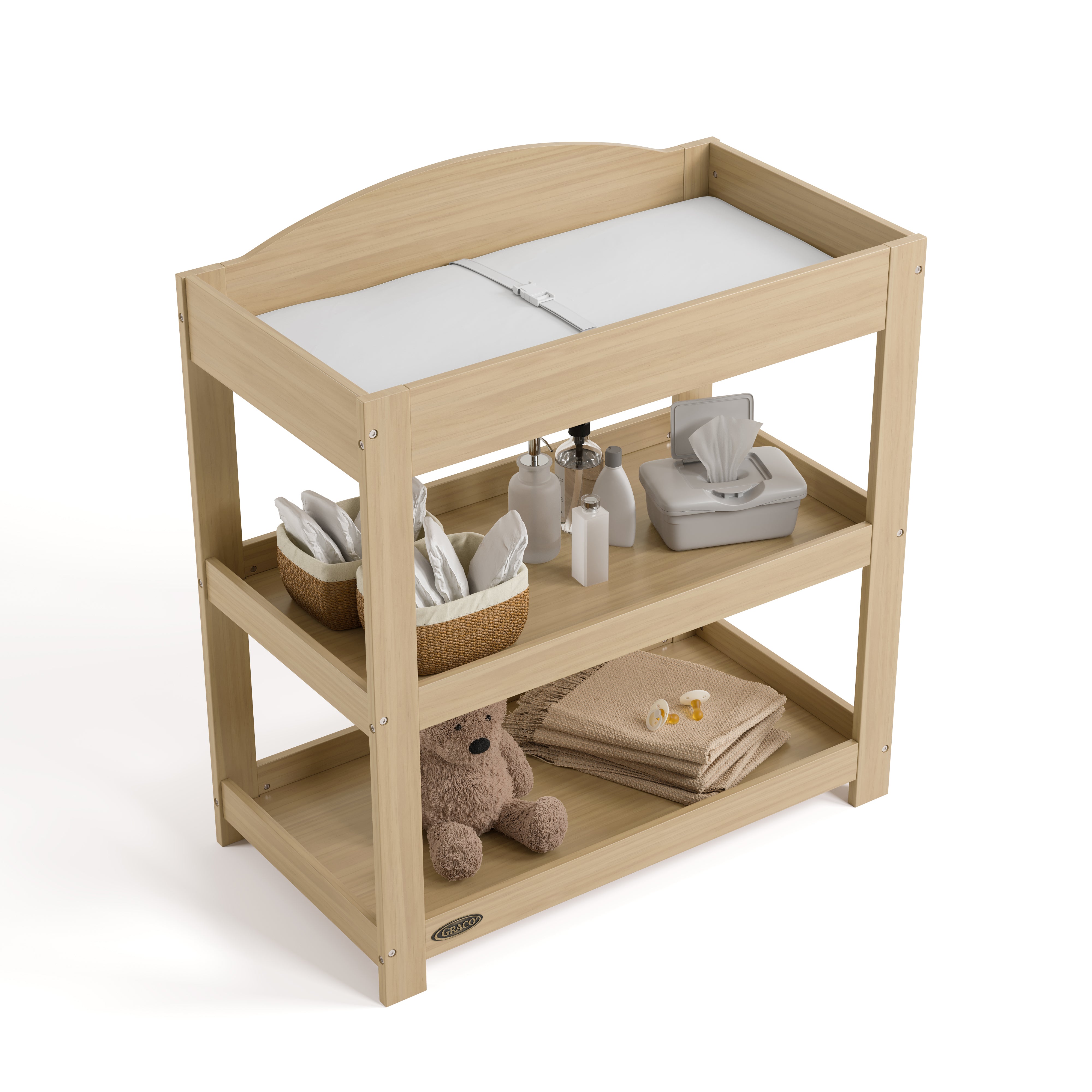 Graco driftwood customizable changing table top view with baby items on bottom shelves