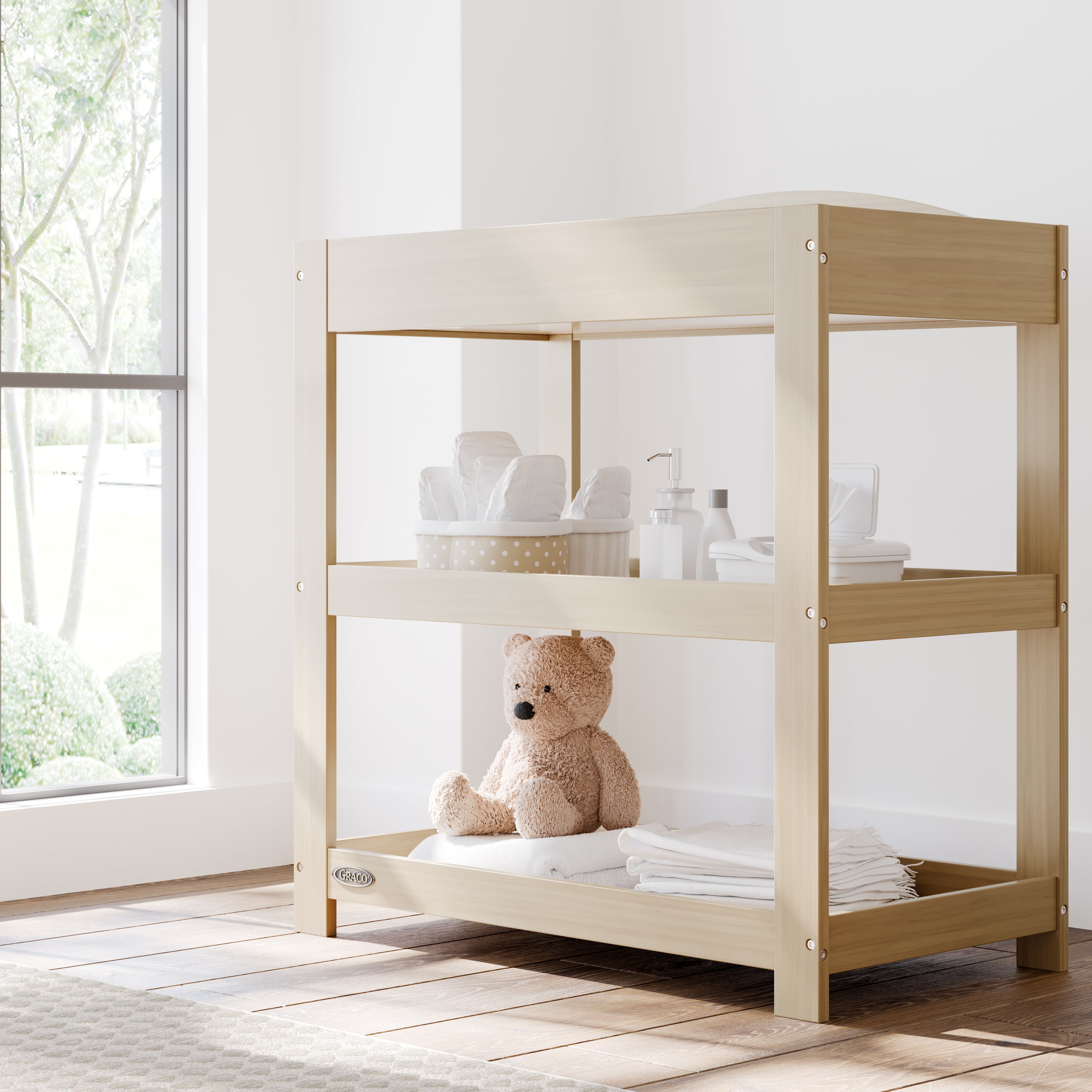 Graco driftwood customizable changing table in nursery