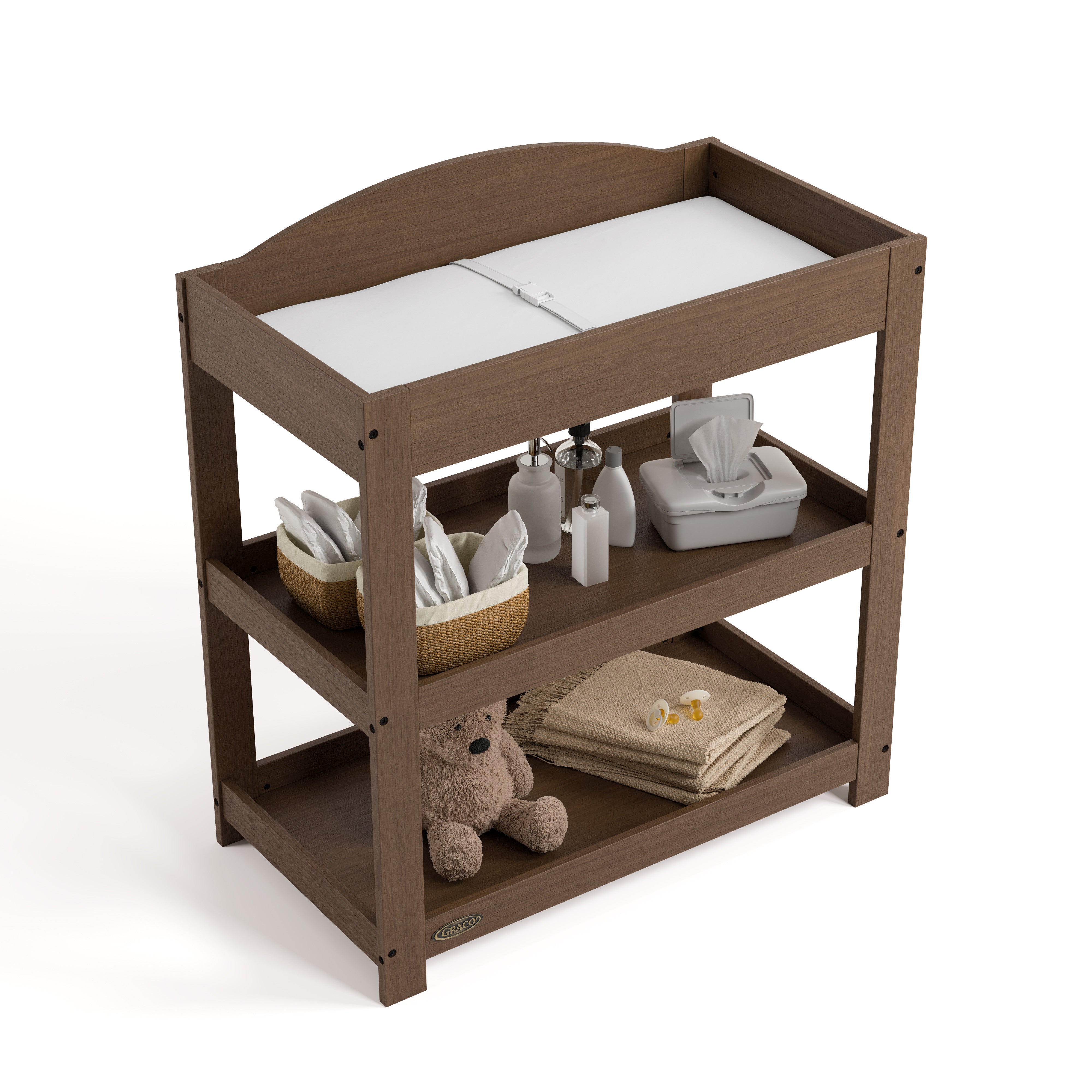 Graco hazelnut customizable changing table top view with baby items on bottom shelves