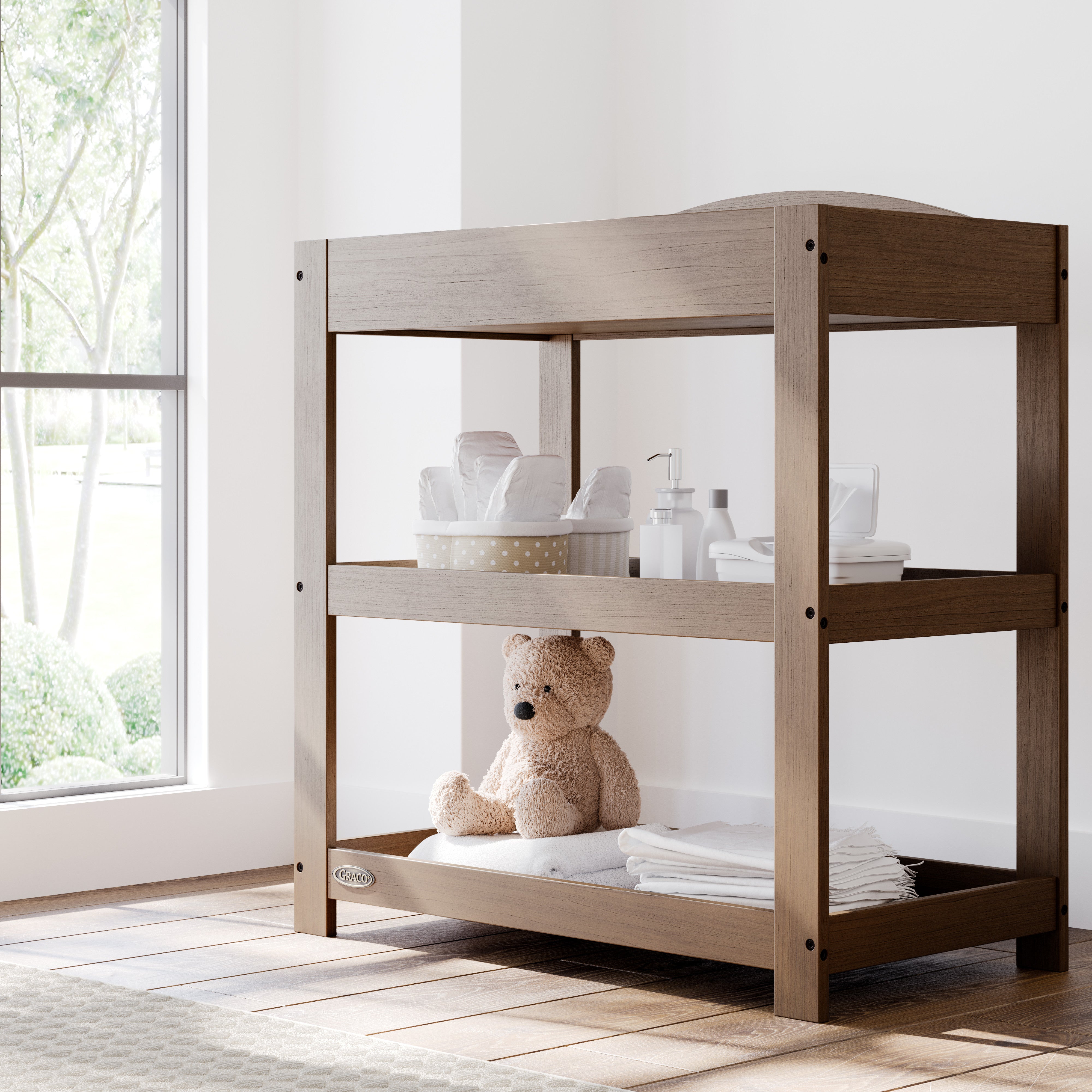 Graco hazelnut customizable changing table in nursery