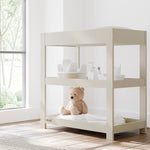 Graco frosted oat customizable changing table in nursery