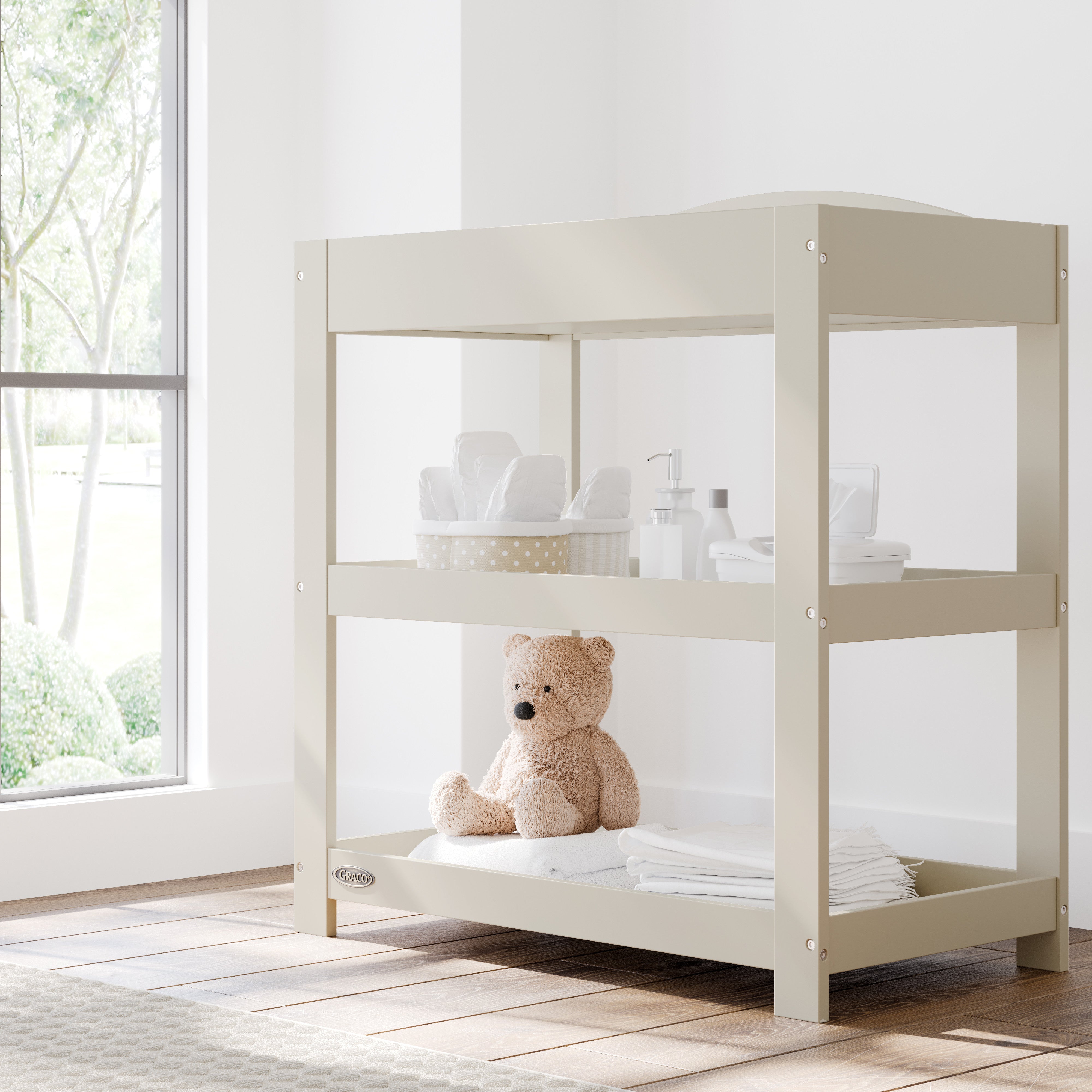 Graco frosted oat customizable changing table in nursery