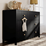 Black dresser in nursery setting
