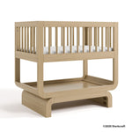 Santorini driftwood bassinet with 2025 Storkcraft copyright on bottom right