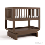 Santorini hazelnut bassinet with 2025 Storkcraft copyright on bottom right