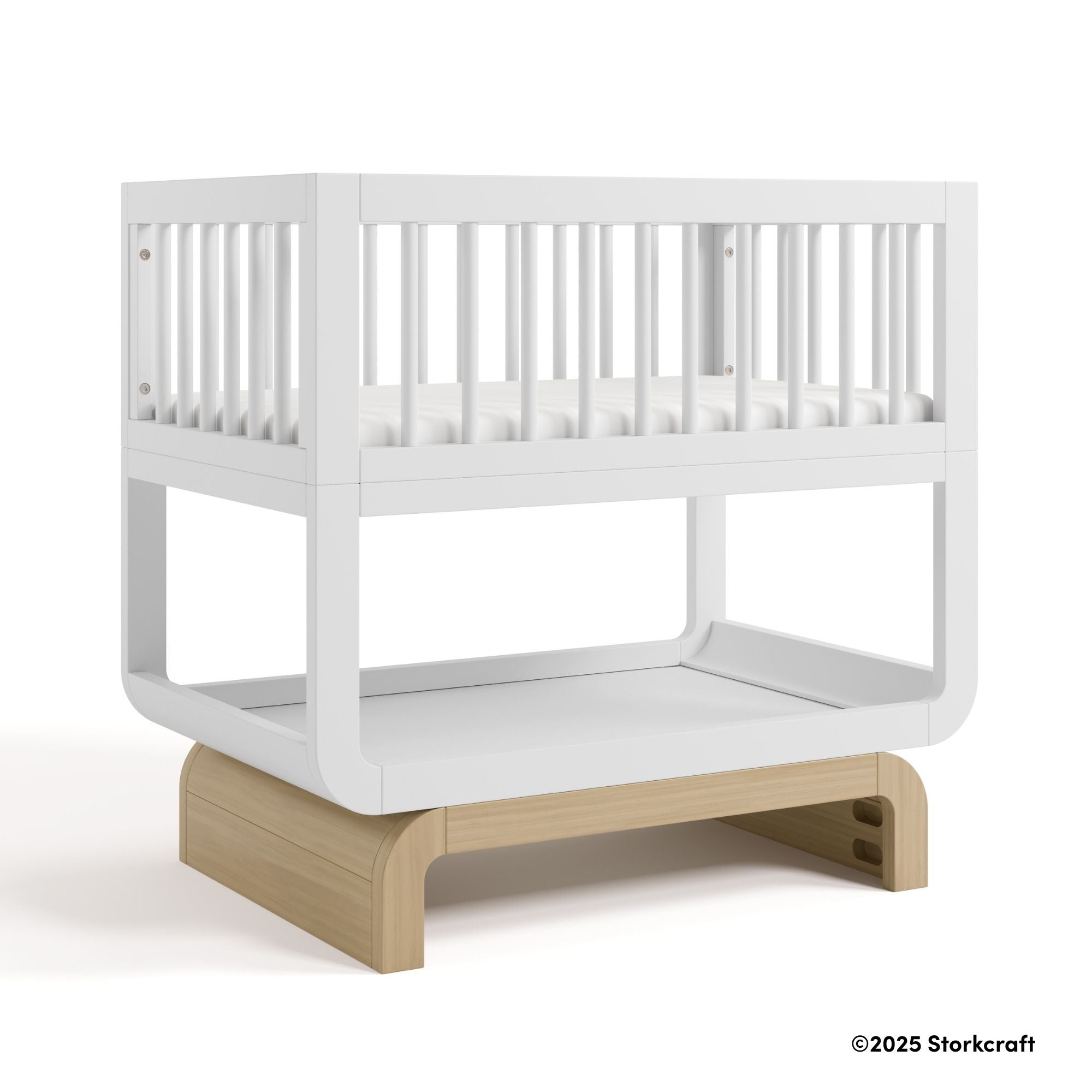 Santorini white with driftwood bassinet with 2025 Storkcraft copyright on bottom right