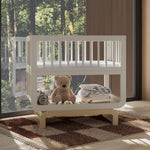 Santorini frosted oat with driftwood bassinet in nursery