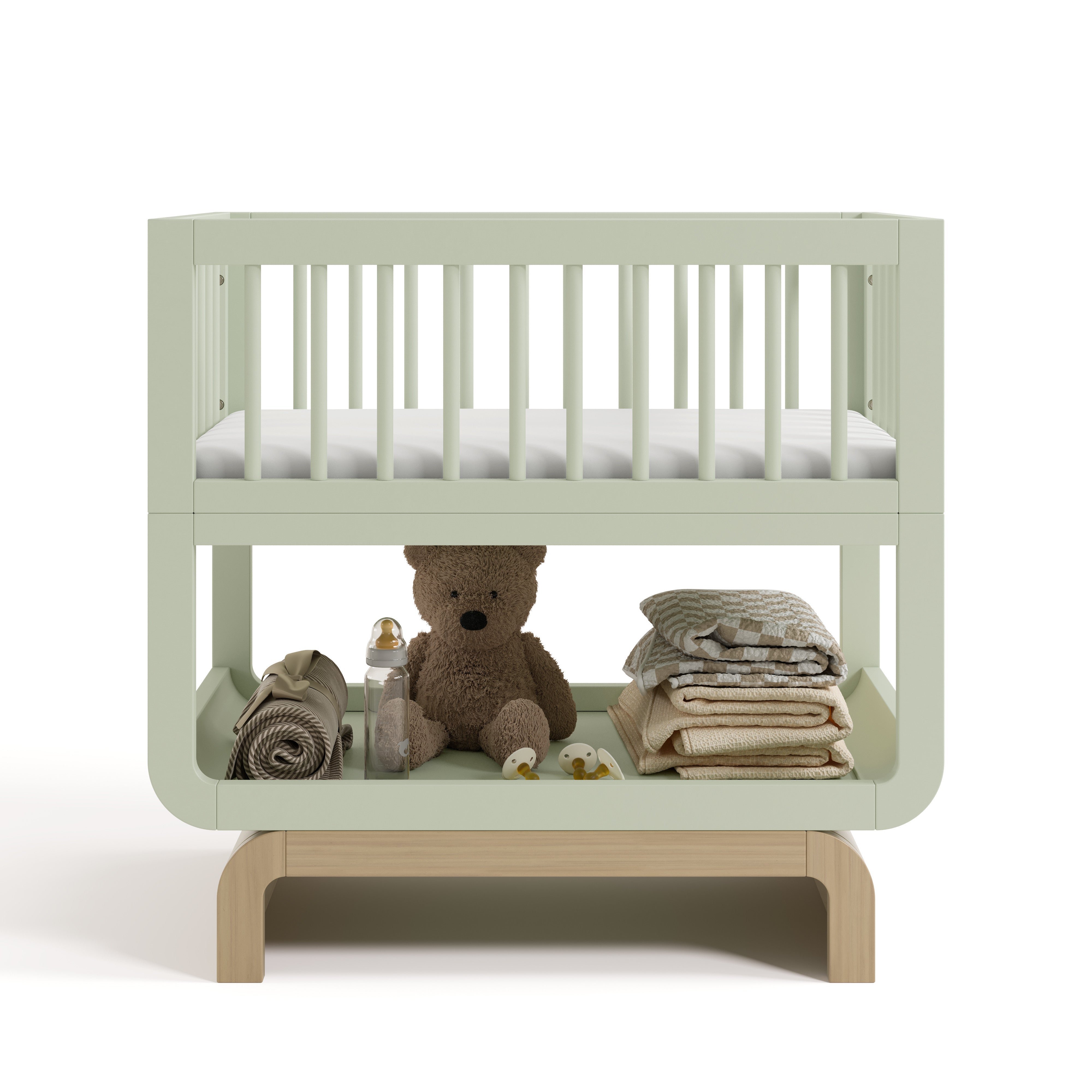 Santorini sage with driftwood bassinet front view with baby items on bottom shelf