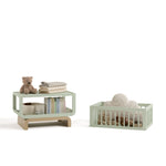 Santorini sage with driftwood bassinet converted to toybox and bookshelf with baby items inside