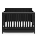 front view of black crib with drawer