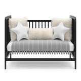 Black crib in toddler bed conversion