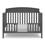 Benton gray crib converted to toddler bed with two guardrails