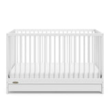 White crib with drawer angled