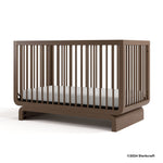 Santorini hazelnut crib with 2024 Storkcraft copyright on bottom right