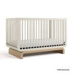 Santorini frosted oat with driftwood crib with 2024 Storkcraft copyright on bottom right