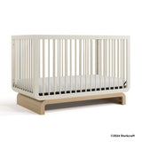 Santorini frosted oat with driftwood crib with 2024 Storkcraft copyright on bottom right