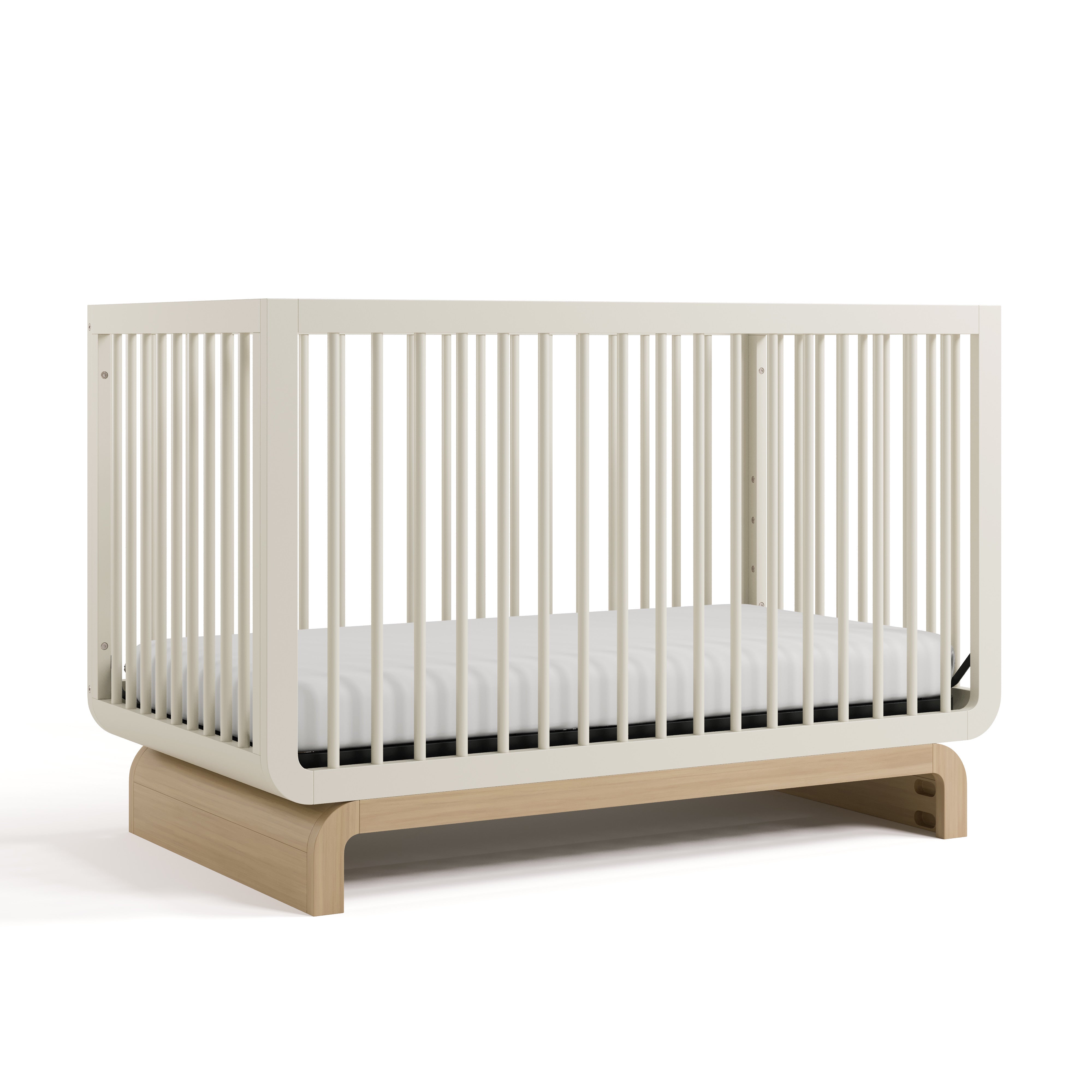 Baby crib in two-tone colorway, at an angled view (Frosted Oat with Driftwood)