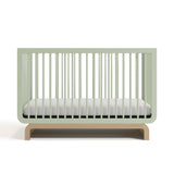 Two-tone sage and natural wood baby crib, at a front-facing angle (Sage with Driftwood)
