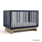 Santorini midnight blue with driftwood crib with 2024 Storkcraft copyright on bottom right