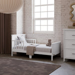 Bailey white toddler bed in kids room by window