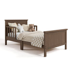 Bailey hazelnut toddler bed with bedding angle view