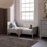 Bailey pebble gray toddler bed in kids room by window