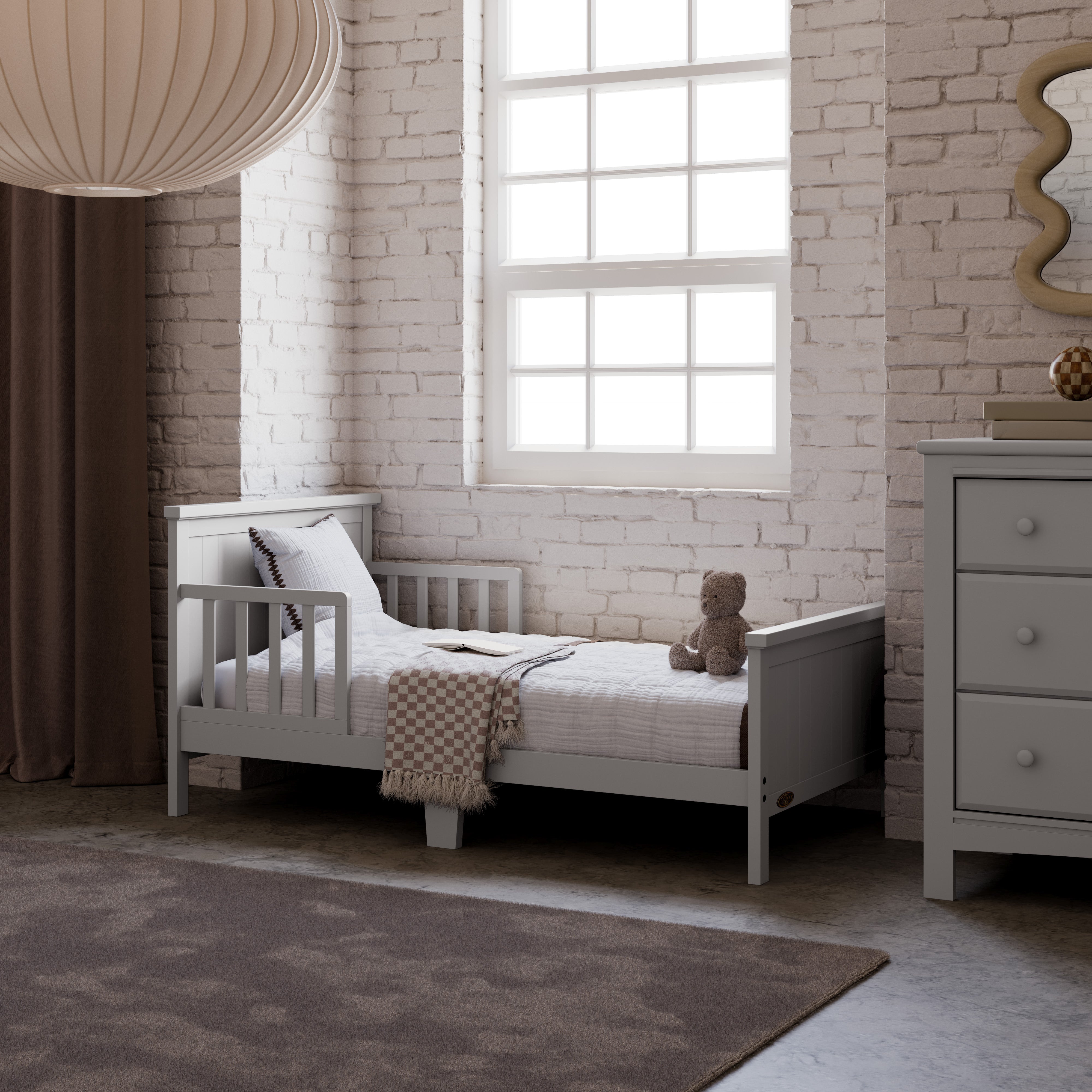 Bailey pebble gray toddler bed in kids room by window