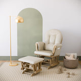natural glider and ottoman with beige cushions in nursery