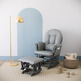gray glider and ottoman with light gray cushions in nursery