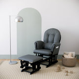 black glider and ottoman with gray cushions in nursery