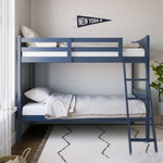 navy bunk bed with fixed ladder angled with bedding in a nursery