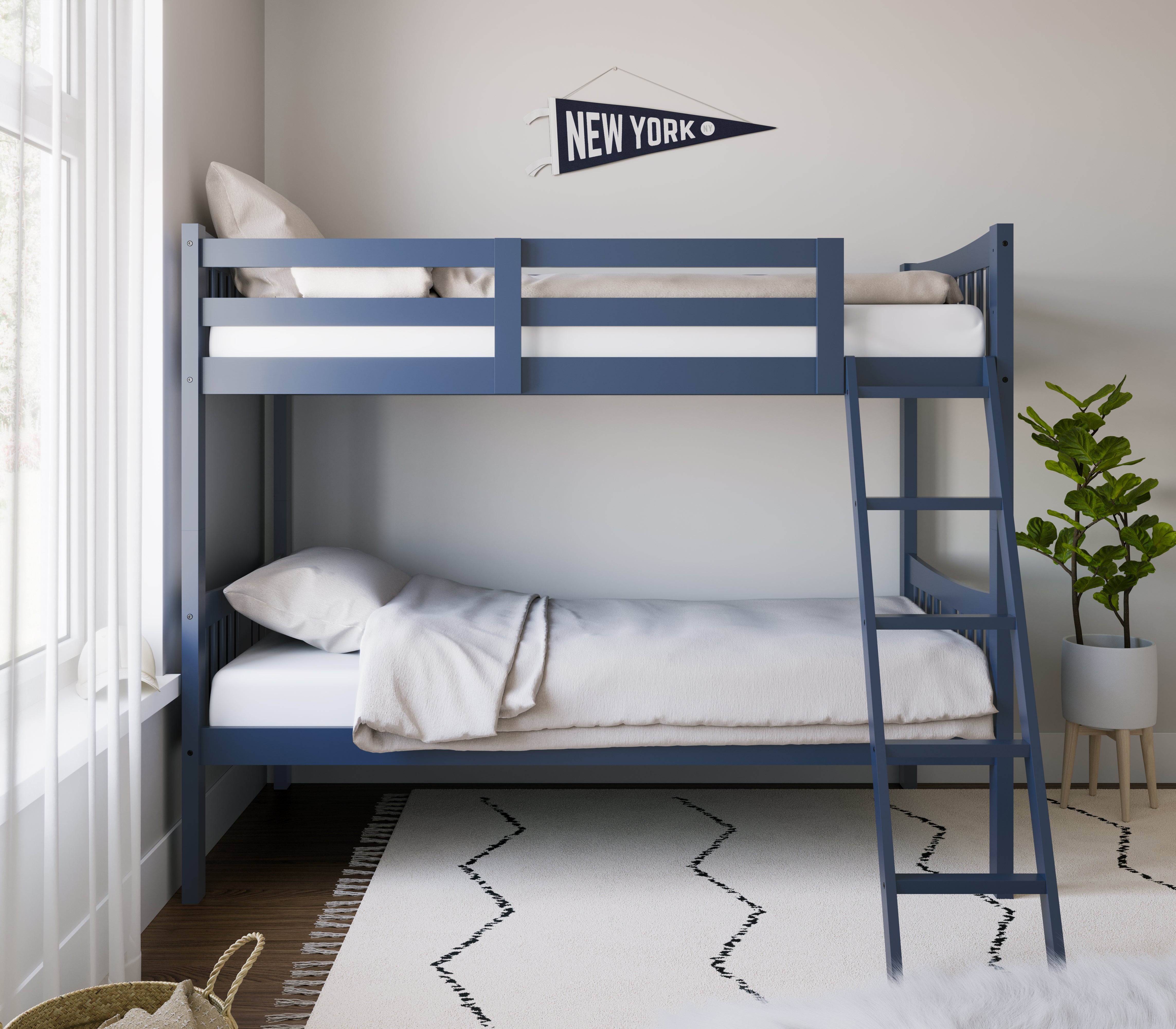 navy bunk bed with fixed ladder angled with bedding in a nursery