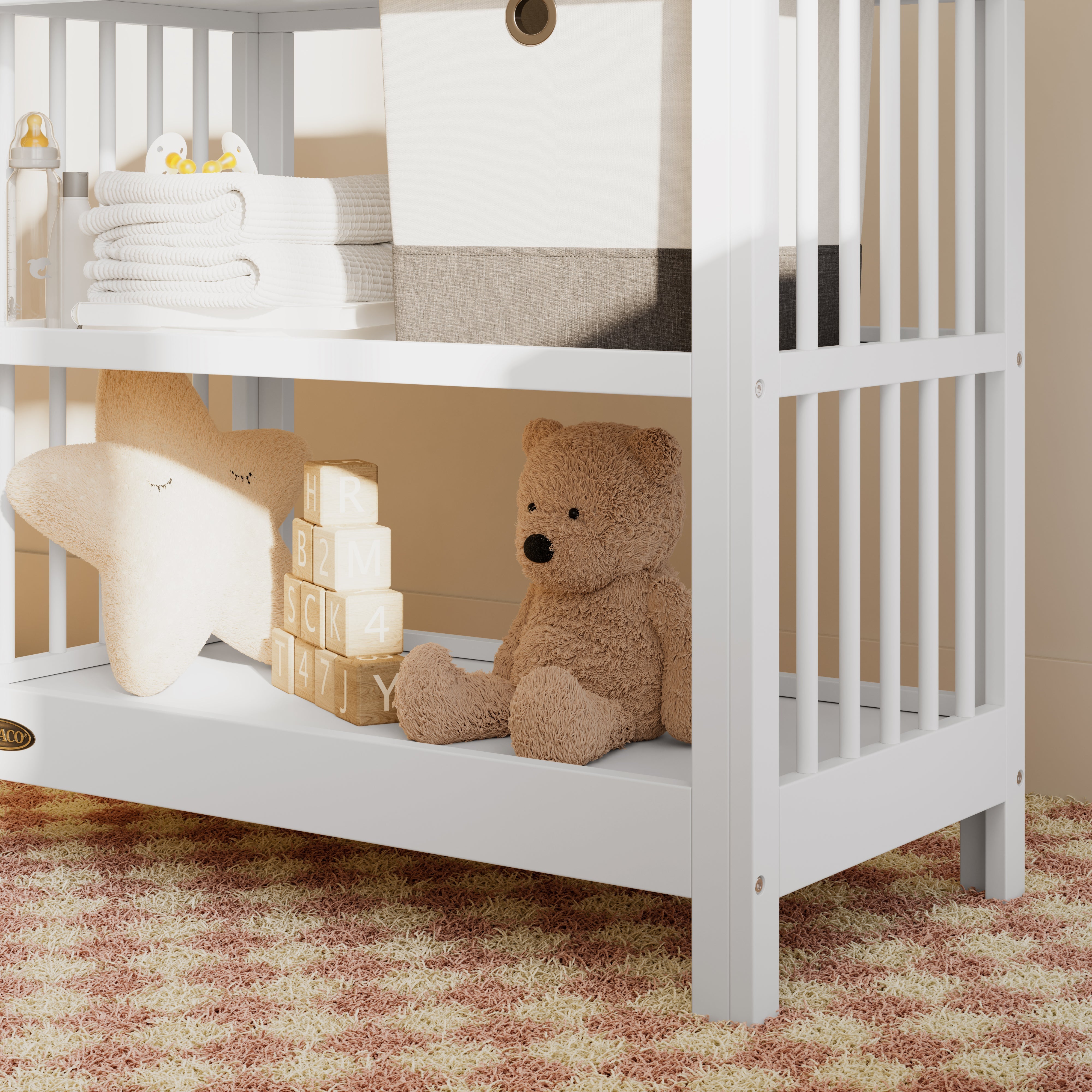 Close-up view of a white changing table in the left corner.