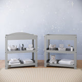 Pebble gray changing table with removable headboard and two open shelves in nursery