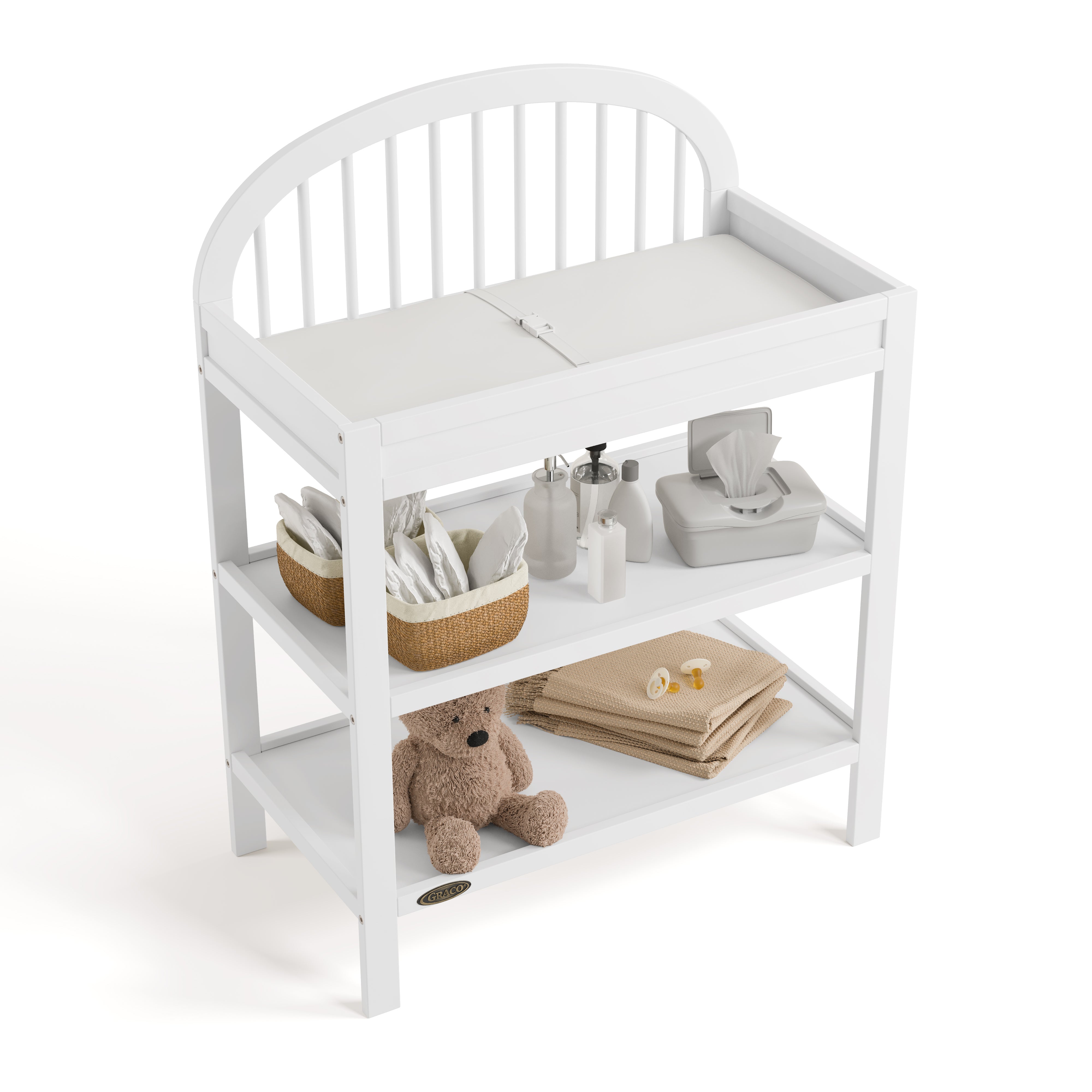 Olivia white changing table top view with baby items on shelves