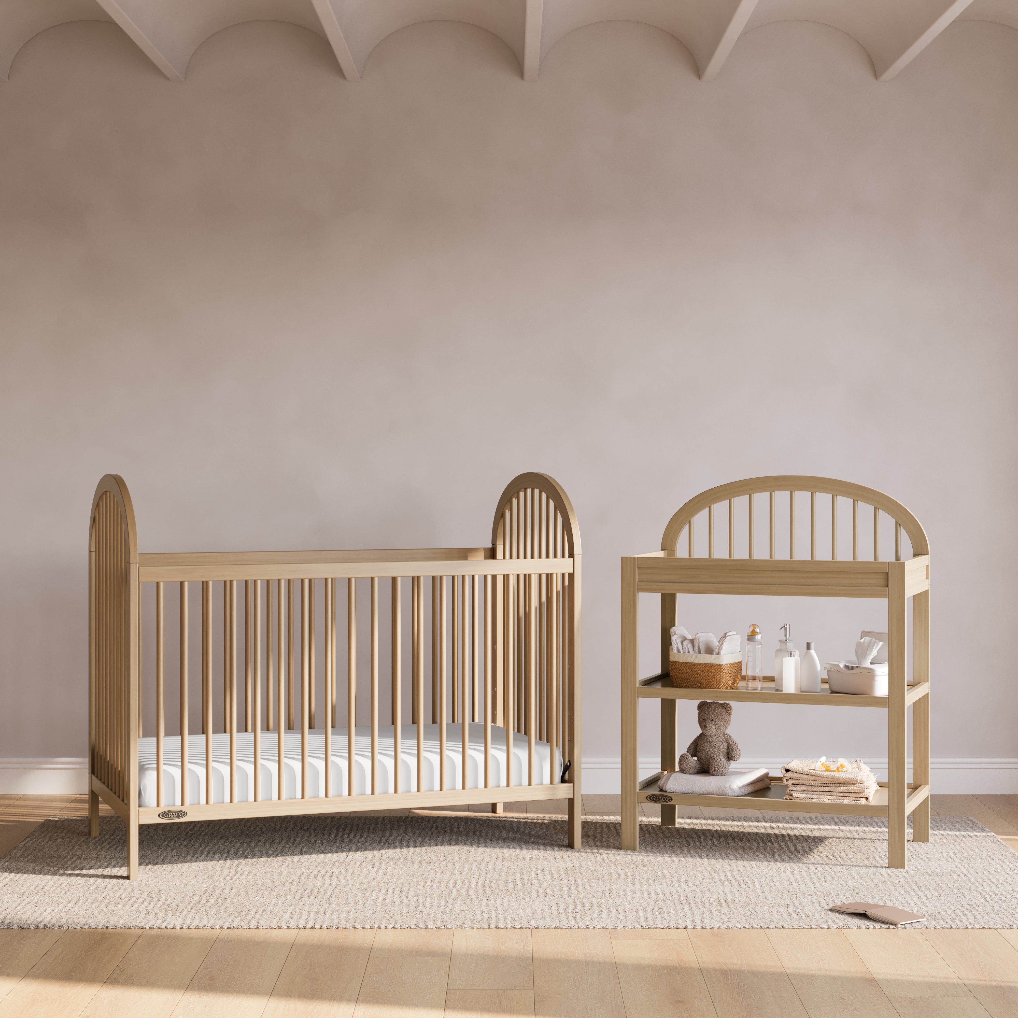 Olivia driftwood changing table in a nursery next to crib