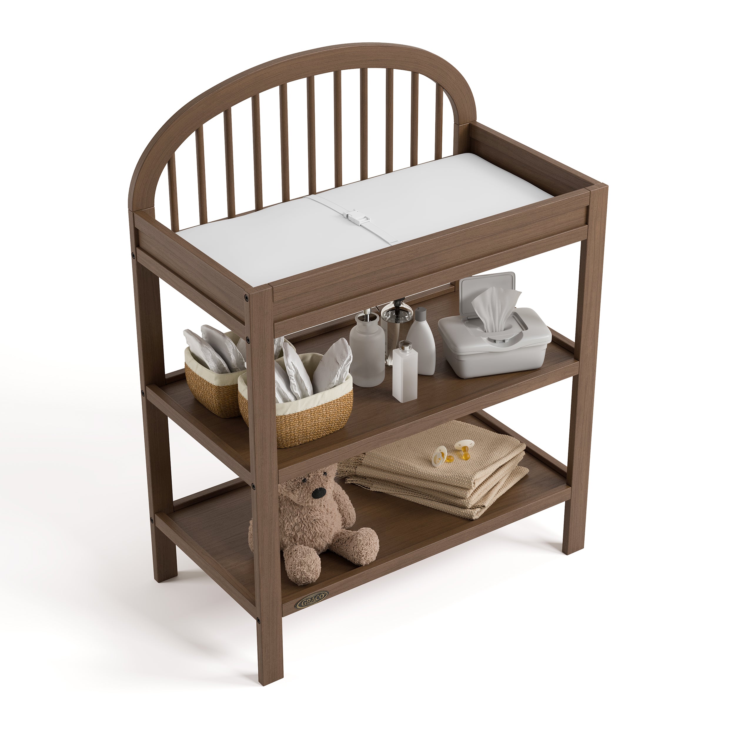 Olivia hazelnut changing table top view with baby items on shelves