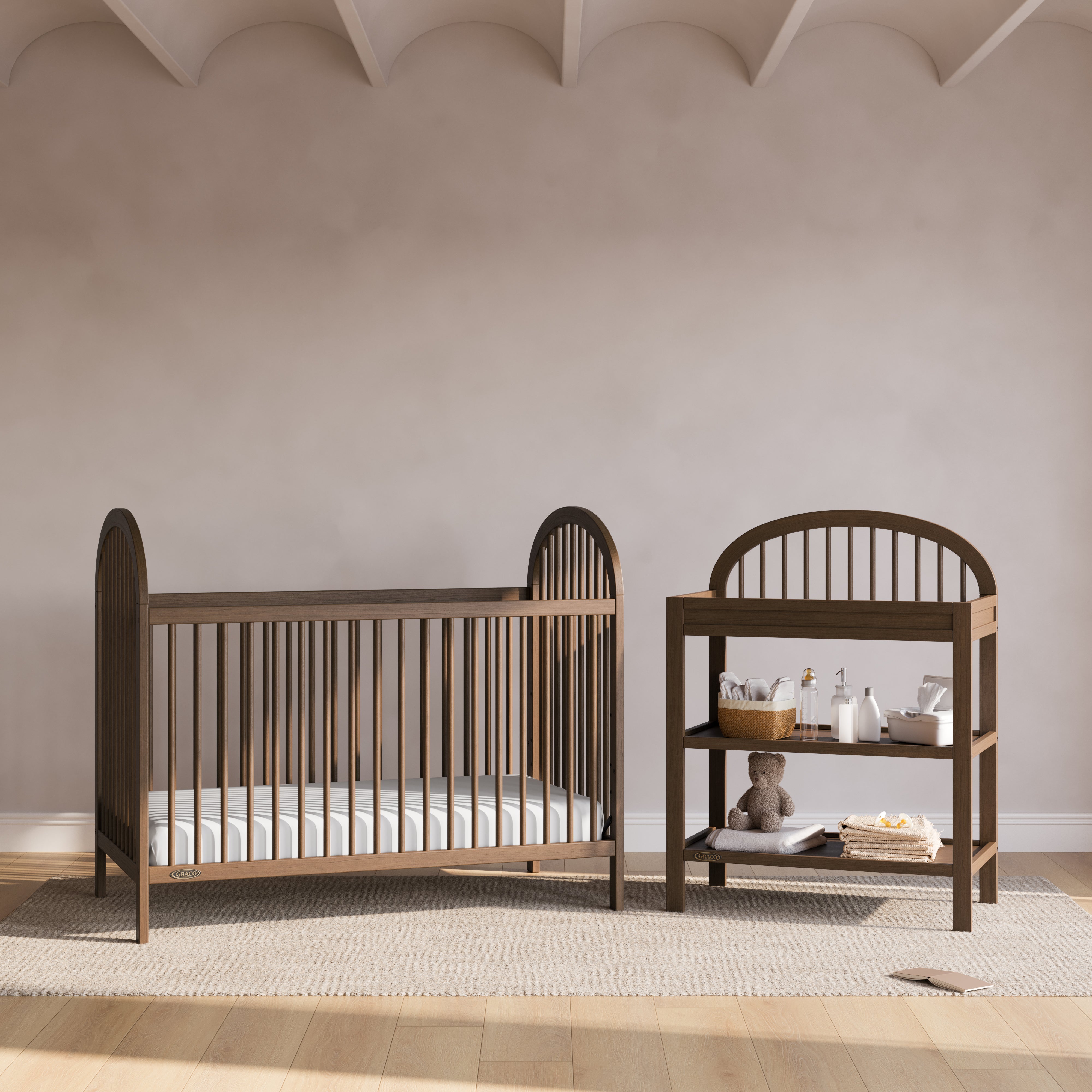 Olivia hazelnut changing table in a nursery next to crib