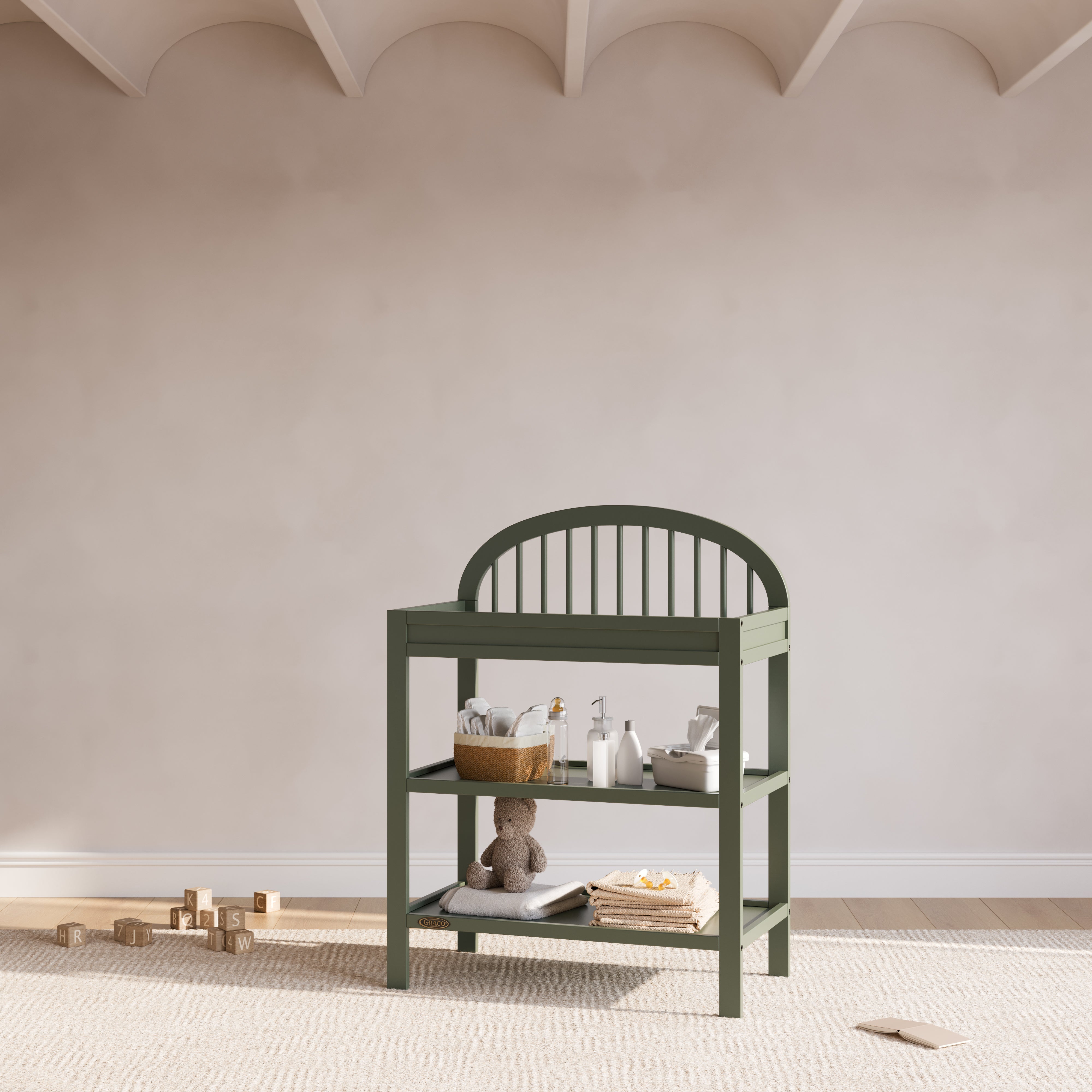 Olivia olive changing table in a nursery