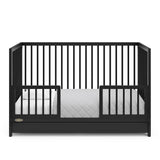 Black Toddler Safety Guardrail Kit with dowels applied in toddler bed