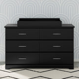 black changing topper on top of 6 drawer dresser in nursery
