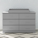 pebble gray changing topper on top of 6 drawer dresser in nursery