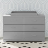 pebble gray changing topper on top of 6 drawer dresser in nursery