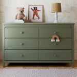 Alpine olive 6 drawer dresser in a nursery