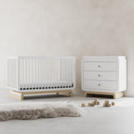 Santorini white with driftwood 3 drawer chest with changing topper in a nursery next to crib