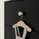 close up view of black dresser with driftwood knobs