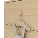 California driftwood 6 drawer dresser close up of drawer knob with baby hanger hanging on it